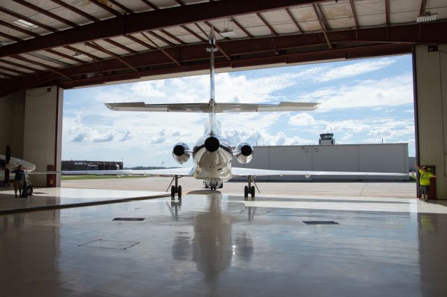 Dassault Falcon 50 (N324U) - I was beyond excited when I got an invite from the Iowa Aviation Promotional Group and Elliott Aviation to tour on the ramp at DSM a private jet. This was my first experience being in one, and I was impressed by how complex these luxurious flying machines are. In this shot the Dassault Falcon 50EX is being towed into her hanger.