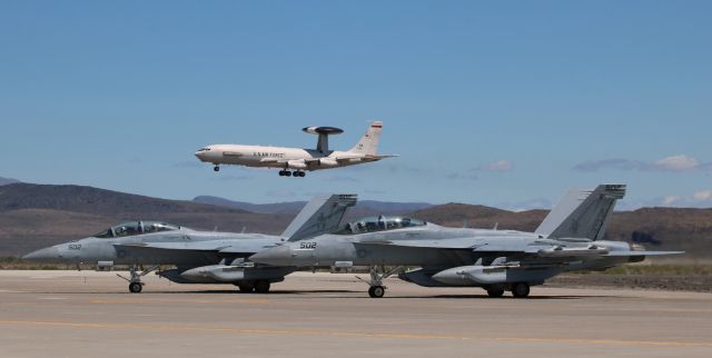 Boeing JE-3 Sentry — - A pair of Navy EA-18G Growlers ...br /... VAQ-131 "Lancers" (NAS Whidbey Island) and VAQ-136 "Gauntlets" (NAS Whidbey Island) ...br /... are notched on Taxiway Alpha awaiting permission to taxi and launch from the inboard Runway 31L while, in the background, a USAF AWACS (Tinker AFB) is on very s/final to the outboard Runway 31R.