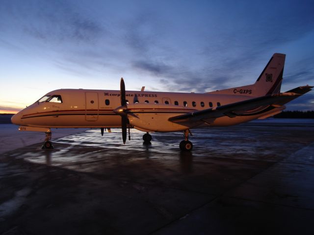 C-GXPS — - Sun rises on the Fort McMurray Airport as Corporate Express Airlines awaits to depart for Calgary International Airport.