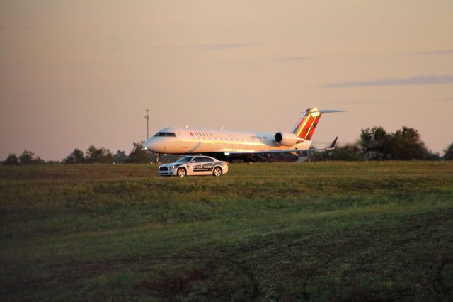 Canadair Regional Jet CRJ-200 (N859AS) - Airport Police cruiser outruns Delta Connection CRJ-200. So it looks like.