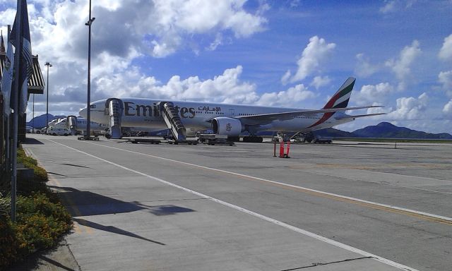 — — - Beautiful 777 sits at the airport in Seychelles. Next to a Mihin Lanka and further down an Air Seychelles. 