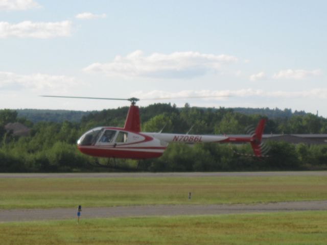 Robinson R-44 (N7086L) - Hovering over the helipad ready to depart.