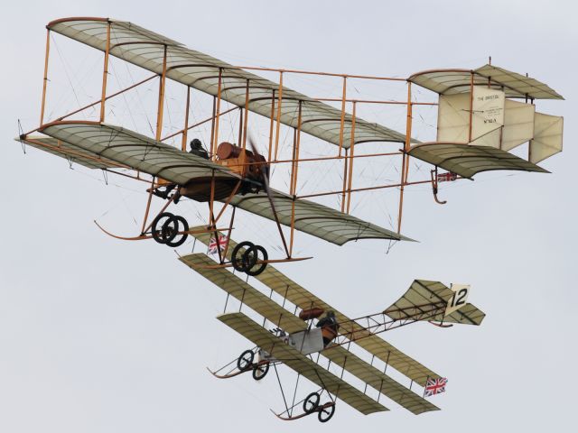 — — - An Avro Triplane breaks away to land as a Bristol Boxkite continues with it's flying display.