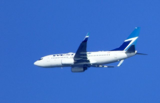 Boeing 737-700 (C-FGWJ) - Shown here is a WestJet Boeing 737-700 a few minutes until landing in the Summer of 2016.