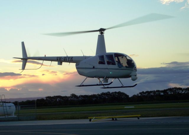 Robinson R-44 (VH-WYR) - A Raven R-44 (VH-WYR) departs a general aviation airport near Brisbane Australia in the twilight.   (Note the FLIR ball located on the helicopters nose.)  In Australia, the R44 rents for $995 (Australian dollars) per hour; seems steep even compared to the prices we pay here in the US!