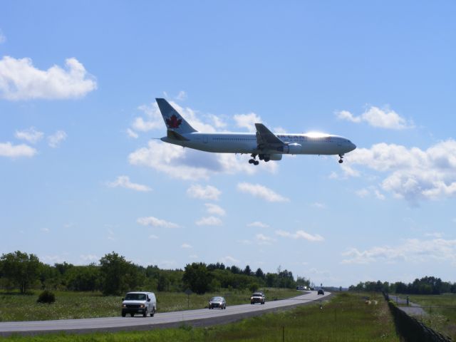 Airbus A330-300 (C-FMWU) - flying over a busy leitrim rd., as this A333 approaches runway #32.