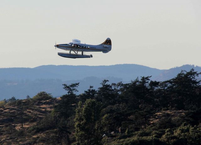 — — - Float plane over Vancouver Harbor