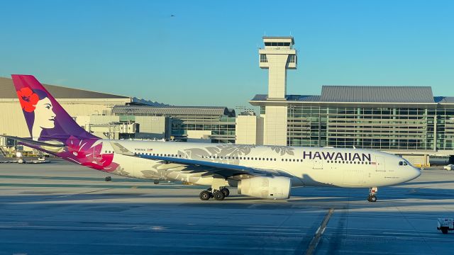 Airbus A330-200 (N380HA) - Airplane taxiiing at LAX with the International Terminal in the background. 