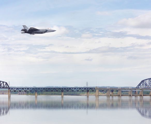 Lockheed F-35C — - This is a composite I made with F-35 flying in backdrop. This was taken from two photos during airshow practice before Thunder over Louisville. The concept is that your eye is drawn to the sky where the F-35 is and you imagine it flying through the scene. 