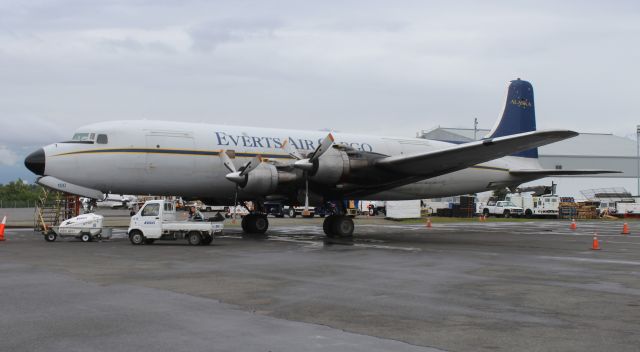 Douglas DC-6 (N100CE) - A 1953 model Douglas DC-6A (built as a C-118A) on the Everts Air Cargo ramp under cloudy skies and light rain at Ted L. Stevens International Airport, Anchorage, Alaska - June 7, 2022.