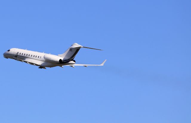 Bombardier Global 5000 (N755RA) - N755RA Smokin it up on departure from Sydney! Cant see the smoke? tilt your screen! Taken from The Mound with a 70-200mm