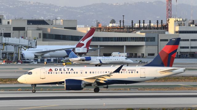 Airbus A220-100 (N136DQ) - Departing runway 25L on taxiway Hotel 9 after arriving at LAX