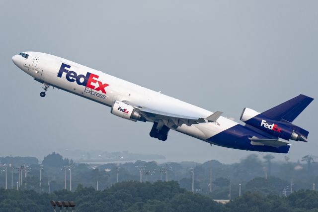 Boeing MD-11 (N593FE) - Up from 19R early on a foggy morning.