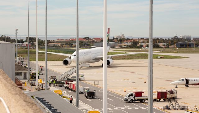 Airbus A330-200 (ZS-SXZ) - A very rare and unusual visitor to our very small local airport. This past weekend saw an influx of over 6000 athletes to our city (read : town) for the Iron Man Competition. On Tuesday 4 September our National Carrier had to replace the usual 11:00 am flight (SA405) of either an A319 or A320, with this wide-body A330-243. Not only for the large number of International athletes heading back to Johannesburg, but also for the Cargo. Besides the usual "baggage", there were also a few hundred bicycles that needed to be loaded up. Flight SA405 (SA410 return) operated the A332 on both Tues & Wed to accommodate all the extra passengers and their unusual cargo.  With a runway length of less than 6,700 foot it becomes a tight fit for this big bird. The apron is too narrow to park "normally" and therefore she had to park at an angle. Being at sea level, and with a typical wind blowing, besides the parking space, our little airport can handle it. The last time a aircraft of comparable size visited our airport was in 2010 for the Soccer World Cup.