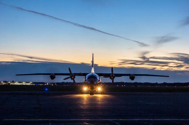 Antonov An-12 (UR-CNT) - UKL5010 turning into parking on the East Ramp after clearing customs on the West Ramp.