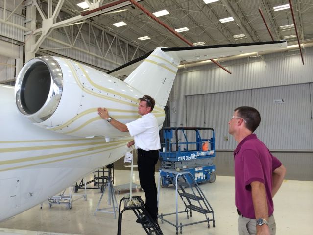 — — - Chip Foose laying out stripes on a friends aircraft. July 2014