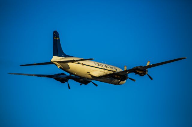 Douglas DC-6 (N747CE) - Departing Anchorage, viewed from Pt. Woronzof.