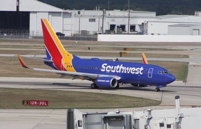 Boeing 737-700 (N421LV) - Taxiing off of Runway 12R after arrival.