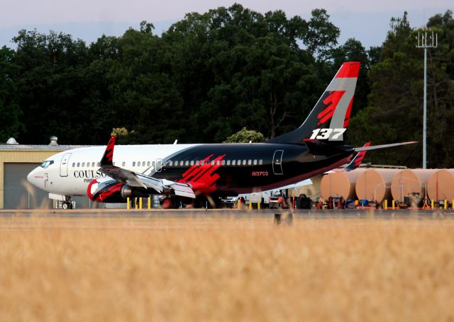 Boeing 737-700 (N137CG) - RDD/KRDD Redding CA USA June 25. 2024 My first photo of T-137 on new colors, though -137 has been to the Redding Air Attack base many times since 2019. This was an early AM photo taken from the east side of the airport and they had not cut the hay yet, so I had to use the white barrier fence to tip toe the photo, as I had not placed the photo ladder in my truck yet. Redding AAB also re-did most of the ramp last fall and spring, upgraded most of the equipment, and made aircraft access easier instead of the old narrow pad lanes of yesteryear!