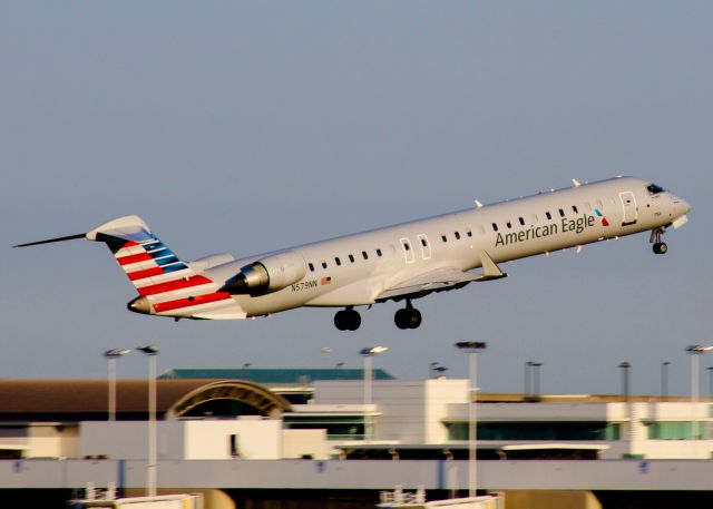 Canadair Regional Jet CRJ-900 (N579NN) - A PSA CRJ departs CVG in the early morning sun.