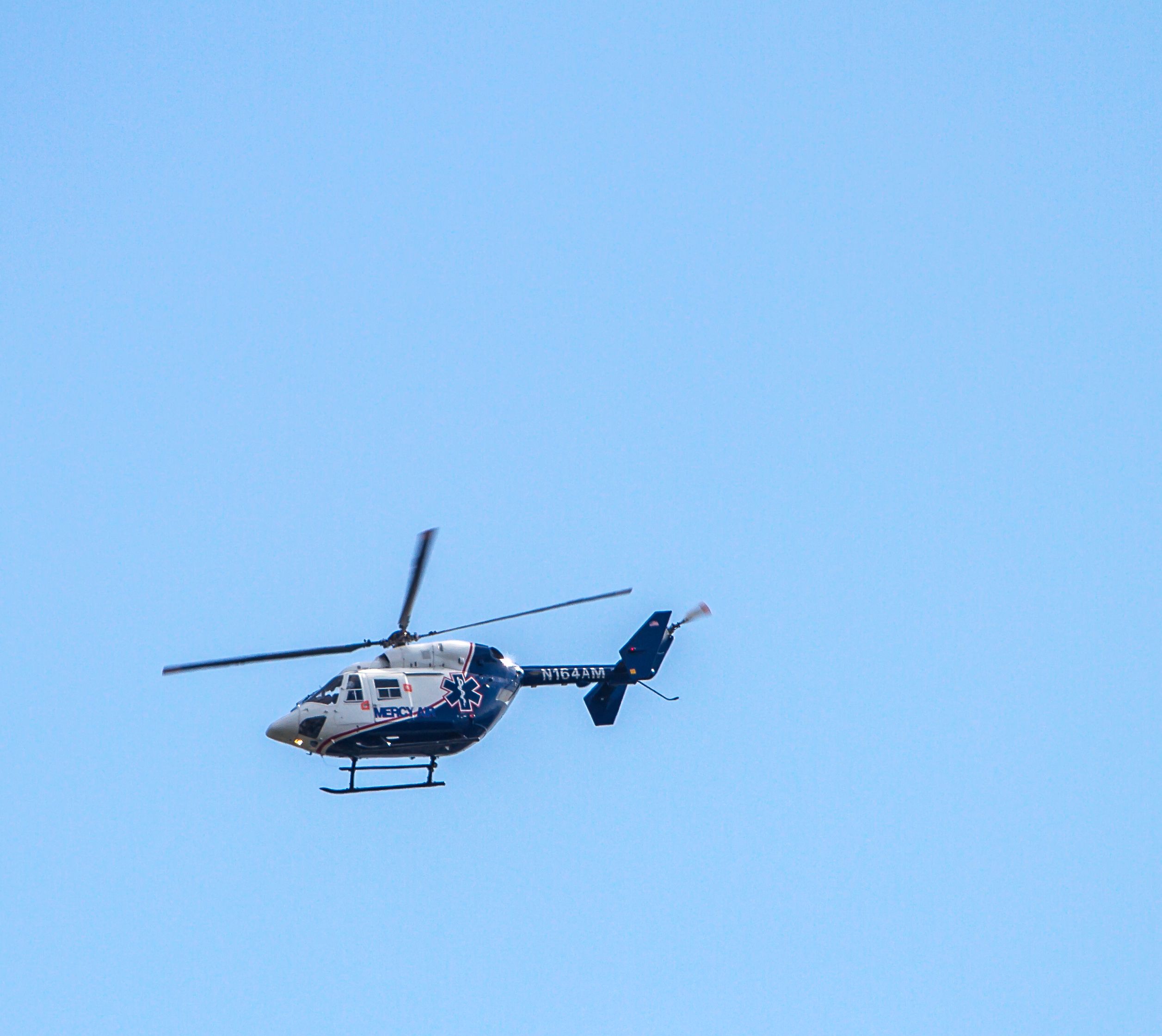 NUSANTARA NBK-117 (N164AM) - Mercy Air eastbound over the LA River near Long Beach....4-12-14