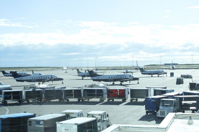 Beechcraft 1900 (N261GL) - 043014 a gaggle of 1900s east end of DIA Concourse A. Includes N261GL, N192GL,and N184UX