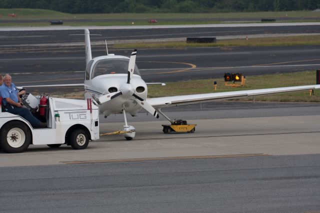 Cirrus SR-22 (N113DJ) - Wheel with the flat tire up on a rolling holder