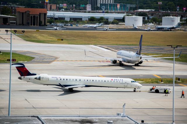 Canadair Regional Jet CRJ-900 (N162PQ) - pushing back before taxiing to runway 4. 9/4/19.