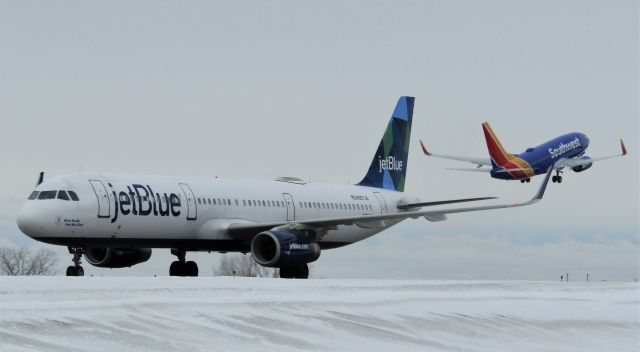 Airbus A321 (N907JB) - One of my FAVORITE shot's I've EVER taken!!! A321 taxiing with a 737 taking off! A321 is taxiing for the gate, 737 is going to LAS.