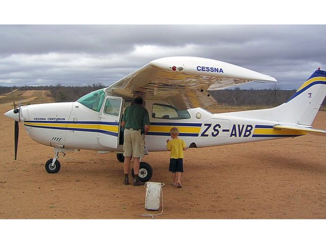 Cessna Centurion (ZS-AVB) - Guenter Schmitz prepares for another low level flight around Ingwelala, South Africa.