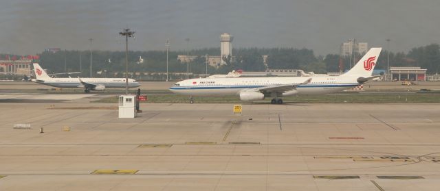 Airbus A330-300 (B-5913) - 6/23/18 B-5913 taxis out as A321 B-1879 starts its roll on Rwy 36R