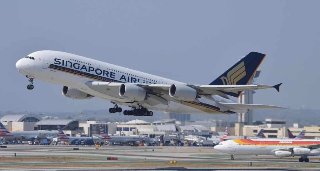 Airbus A380-800 (9V-SKN) - 9V-SKN just after lifting off from runway 25L at LAX. I have never uploaded a photo of an A-380 before because I think they are just ugly (cool to see and hear, but "photo ugly". I decided to upload this one for 3 reasons though: br /1. It is pretty rare for A-380s to use 25L for departure, but they have 24R, the normal A-380 departure runway, closed for construction which will make this a somewhat rare opportunity especially once they open 24R again.  br /2. Despite what I think about the a/c, the Singapore livery DOES look pretty sharp in my opinion.br /3. The Iberia A-340 being on the right of this photo because it was so hot and this spot is so far away, it was impossible to get a shot of that one by itself that wasnt distorted.    