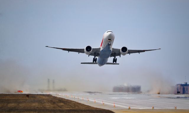 BOEING 777-300ER (80-1111) - Head on shot of the JASDF Triple 7 cleaning the grooved runway with its jet blast and wing tip vortices, which were like mini tornadoes. 