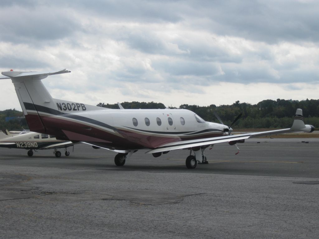 Pilatus PC-12 (N302PB) - With dark, overcast skies overhead, this PC12 rests after arriving from Belmar, NJ (KBLM).