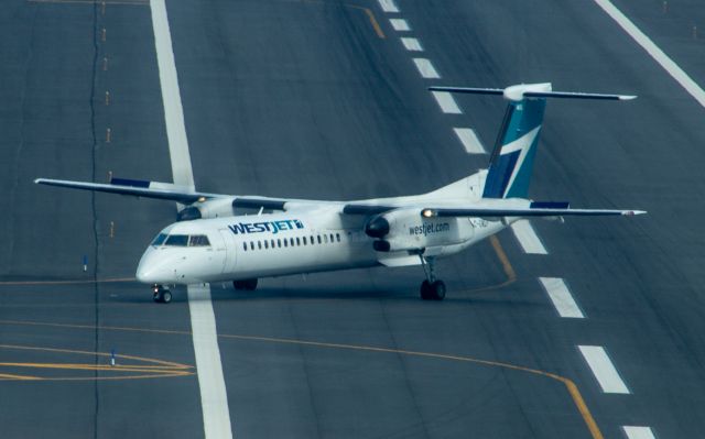 de Havilland Dash 8-400 (C-GWEP) - West Jet Encore taxis off the active at Boston Logan on 10 June 2022. Taken from the Hyatt Regency Boston Harbor Hotel.