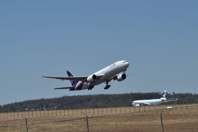 Boeing 777-200 (HS-TJG) - Thai 777 lifts off from 16 while a Cathay A330 taxies for departure