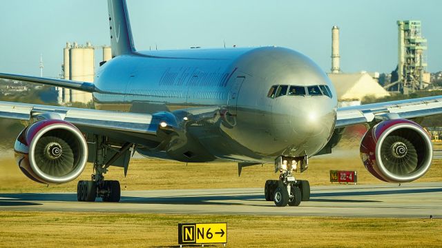 Boeing 777-200 (N819AX) - Exiting 4 after arrival, Washington State arriving for the Alamo Bowl.