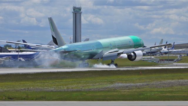 BOEING 777-300 (A6-EGT) - BOE198 (LN:1024) makes tire smoke on touchdown to runway 16R and completion of its maiden flight on 6/6/12.