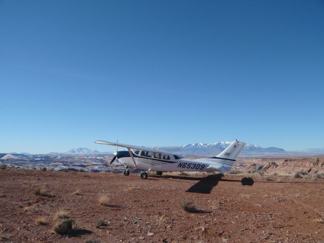 Cessna 206 Stationair (N65309) - OK3 AIR T206H parked at Angels Point, Utah.  Henry Mountains in the background