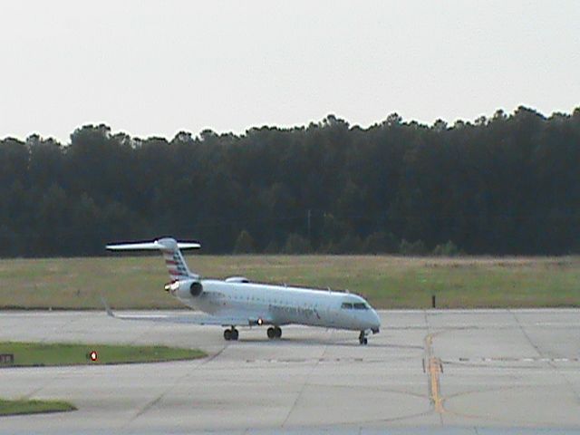 Canadair Regional Jet CRJ-700 (N509AE) - American Eagle Flight 3749 From KLGA is taxiing down the road after landing 5L at KRDU. Taken 6/20/2013.