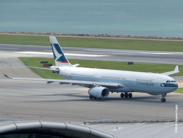 Airbus A330-300 (B-LAF) - Standing atop Terminal 2 at HKG.