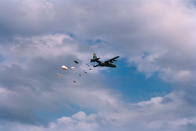 Lockheed C-130 Hercules — - Load is away from a C-130 at the Air Power Air Show in KOKC