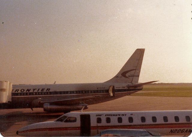 Boeing 737-100 (N737F) - This photo went through the Joplin EF-5 tornado last year. Sorry for the damage to it. Enjoy it for what it is. 1978? Frontier Sitting at the ramp and a Metro. KJLN Joplin Regional Airport.