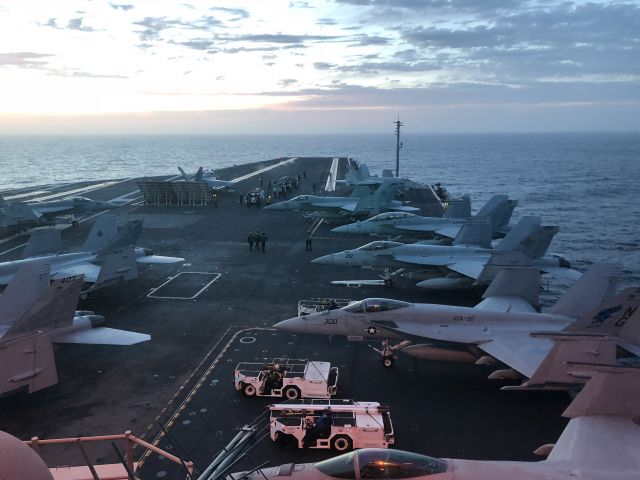 McDonnell Douglas FA-18 Hornet — - The Super Hornets and Growlers of Carrier Air Wing Nine (CVW-9) conduct flight operations as the sun sets on April 21, 2018 aboard the U.S.S. John C. Stennis (CVN-74).