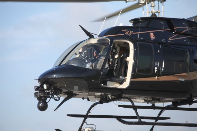 Bell 407 (N617HC) - With little time to move to avoid the debris flying around under this helicopter, I turned my back, pulled my hat down over my eyes and waived him by.  Note the small decal behind the door and up by the roof line.  The Georgia decal seems to be the only State Police marking.  