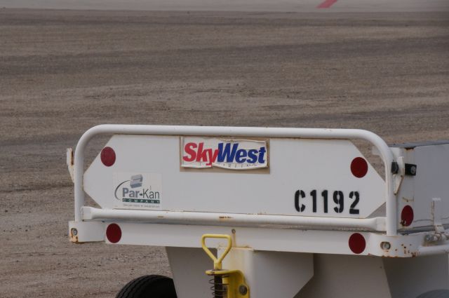 — — - A Skywest  baggage cart.  I would love to own one of these.