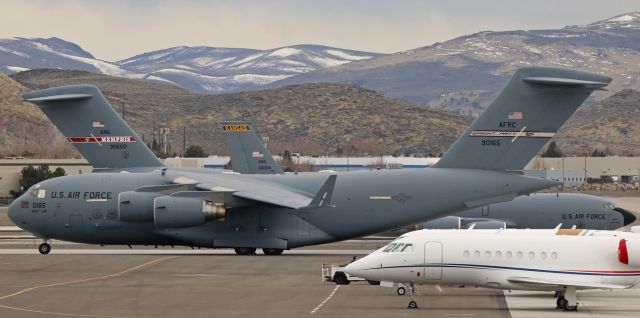 Boeing Globemaster III (99-0165) - Thousands and thousands of tons of USAF heavy metal here on the Atlantic Aviation ramp at Reno Tahoe International.  Three of the many visiting military metal aircraft are visible (or partially visible) in this shot:  a C-17A Globemaster III (99-0165) of the 445th AW at Wright-Patterson in Ohio is front and center.  Next, just behind it, is 63-8004, a KC-135R from Kansas, and behind that is a Memphis-based Globemaster.  Not visible in this photo because they are ramped behind the Memphis C-17 are three more aircraft: a C-17A (02-1112) displaying the Mississippi tail flash of the 172nd AW, another KC-135R (63-8030) from Hawaii, and a C-130 from Channel Islands. br /Click on FULL for best Q viewing.  PS: That Falcon looks a little out of place in that lineup. (Grin)