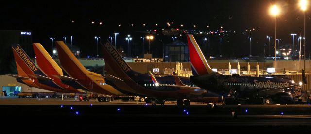 Boeing 737-700 (N7816B) - Southwest Airliness newest special livery, the Disney COCO movie special paint 737 (N7816B), is the closest of SWAs seven fleetbirds that spent their overnight hours at Reno Tahoe International.  Five of those RON aircraft are visible in this across-the-airport night shot taken at 4:50 AM.  Although all seven of Southwests RONs were parked at RTIAs Concourse "B," the other two were not visible from this angle on Charlie Taxiway.