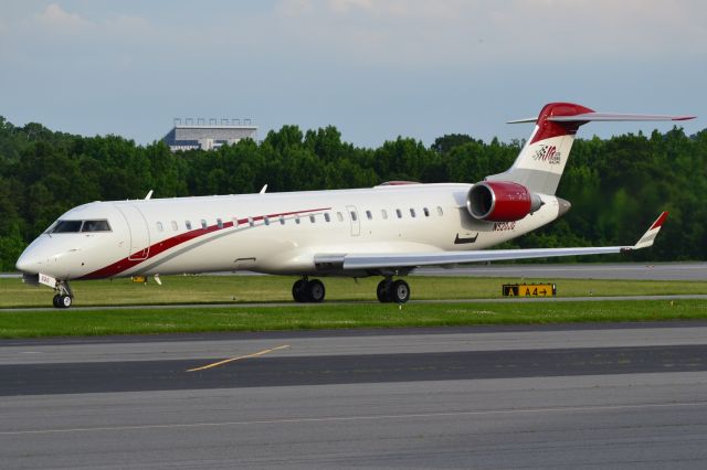 Canadair Regional Jet CRJ-700 (N520JG) - JOE GIBBS RACING INC arriving at KJQF with the Charlote Motor Speedway in the background - 5/30/18