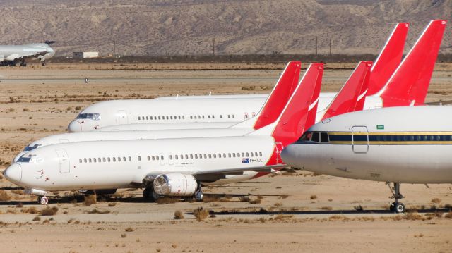 BOEING 737-400 (VH-TJL) - Qantas corner at VCV with a resident L-1011 in the foreground and an ex-Cathay Pacific Cargo 747-200F in the background. VH-TJL is now a freighter with ASL Airlines Hungary, registered as HA-FAX.